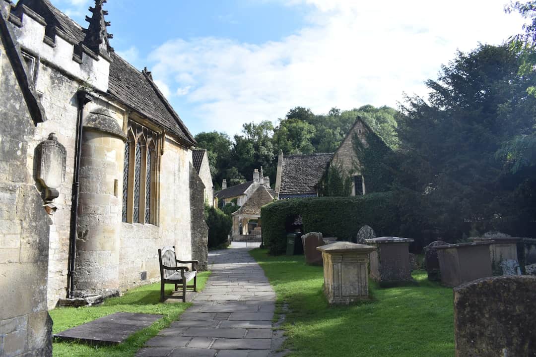 Outside the 13th Century St. Andrew's Church in Castle Combe Village, North Wiltshire, UK – Photo by Martina Jorden | Castle Combe England