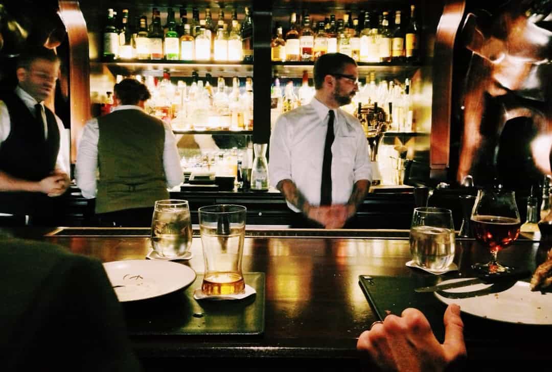 Pub interior with bar men in the Cotswolds Village of Castle Combe, North Wiltshire, UK – Photo by Taylor Davidson| Castle Combe England