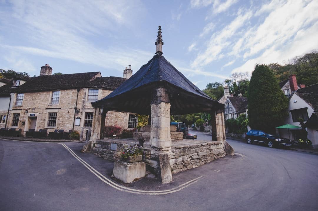 View of the market cross in Castle Combe Village in the Cotswolds, Wiltshire, UK - Photo by Ivy Barn | Castle Combe England