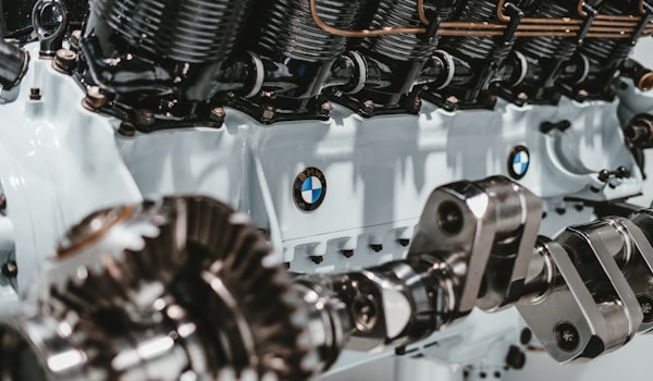 The image displays a close-up view of a BMW engine, showcasing its intricate design and engineering details.