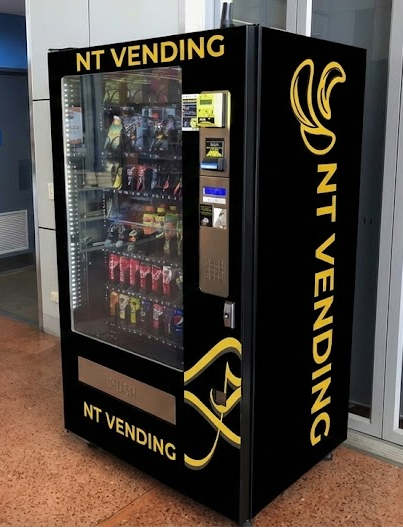 NT Vending snack and drink machine installed in a modern Darwin workplace, fully stocked with chips, chocolates, soft drinks, and energy drinks. Showcases a professional vending solution for businesses across the Northern Territory.