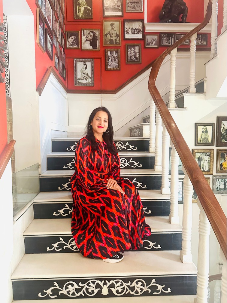 Meghna Patel on red staircase at Jaipur