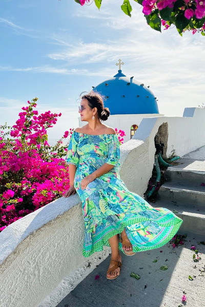 Meghna Patel seated by a blue dome with bougainvillea