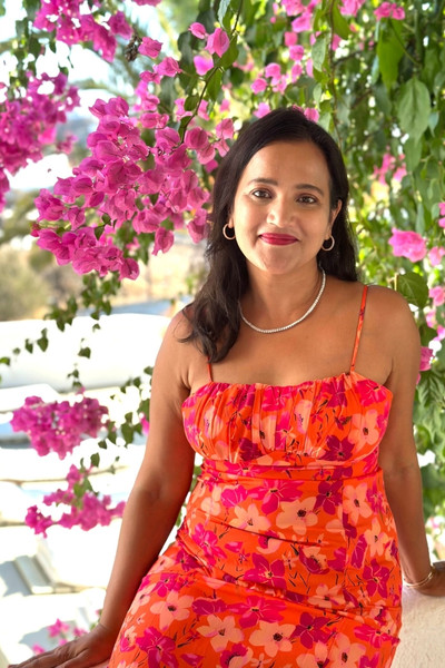 Meghna Patel close-up under bougainvillea in Mykonos