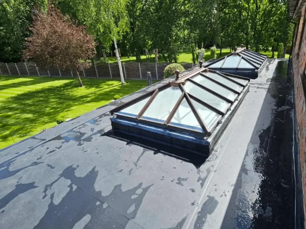 Luxury residential extension featuring integrated glass roof lanterns on a modern, weatherproof flat roof system. Installed by Norfolk Exterior Solutions.