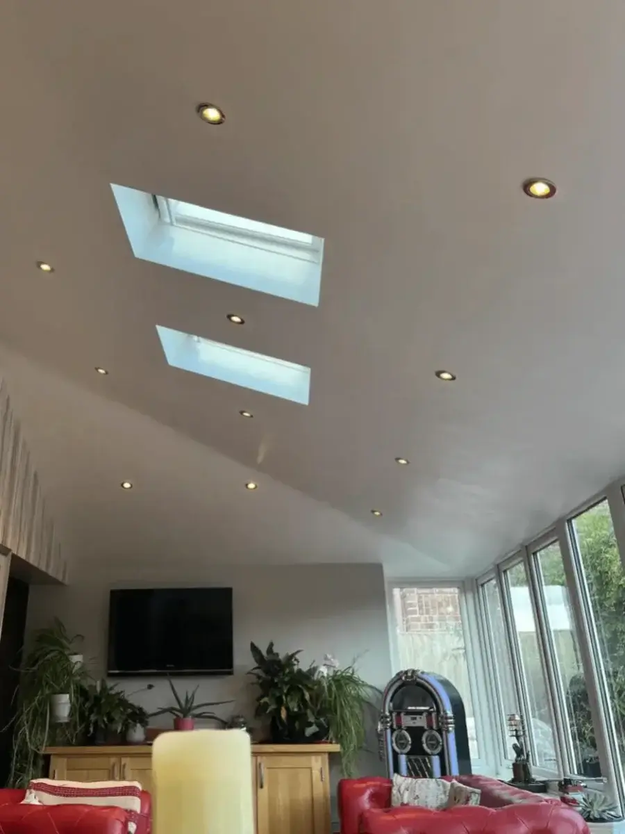 Finished internal vaulted ceiling of a warm roof conversion featuring integrated energy-efficient LED spotlights and Velux rooflights.