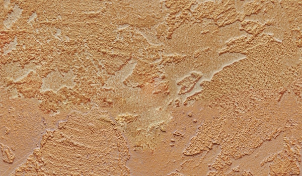 A close-up view of a textured wall painted in a rich brown color.