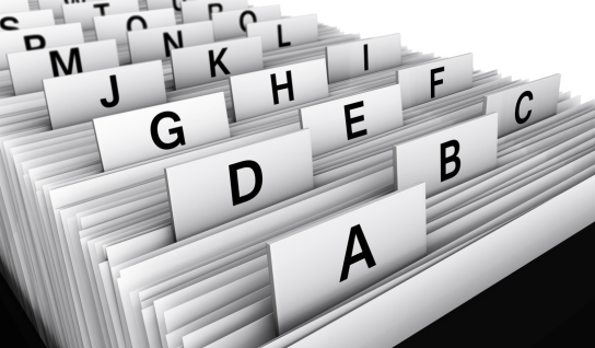 Collection of four insulated travel bottles on wooden shelf.