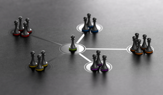 Desk with leather desk pad, walnut desk organizer, wireless keyboard and mouse, and porcelain mug.