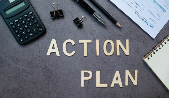 Desk with leather desk pad, walnut desk organizer, wireless keyboard and mouse, and porcelain mug.