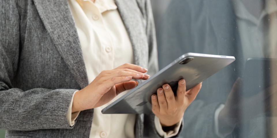 Collection of four insulated travel bottles on wooden shelf.