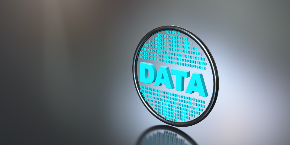 Desk with leather desk pad, walnut desk organizer, wireless keyboard and mouse, and porcelain mug.