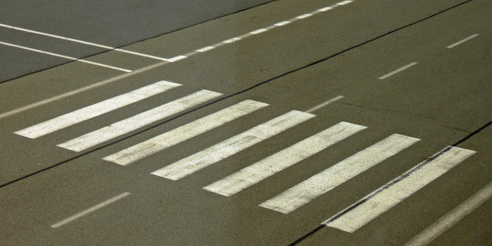Collection of four insulated travel bottles on wooden shelf.