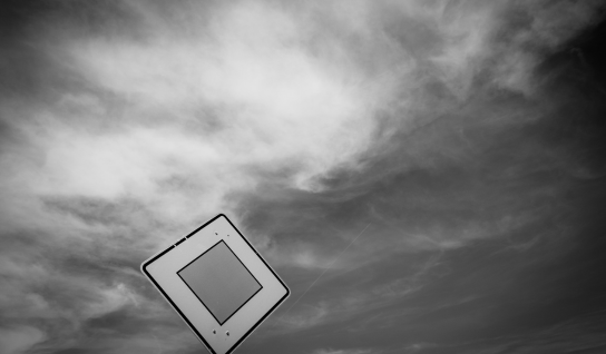 Desk with leather desk pad, walnut desk organizer, wireless keyboard and mouse, and porcelain mug.