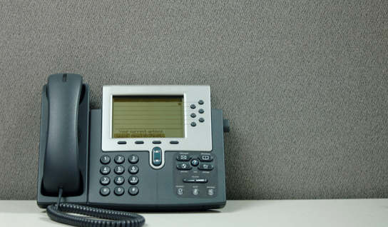 Collection of four insulated travel bottles on wooden shelf.