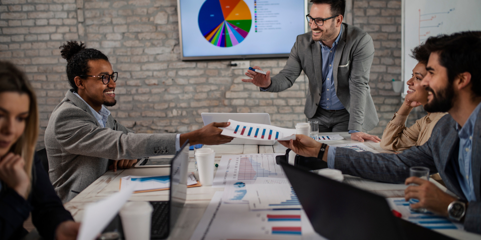 Collection of four insulated travel bottles on wooden shelf.