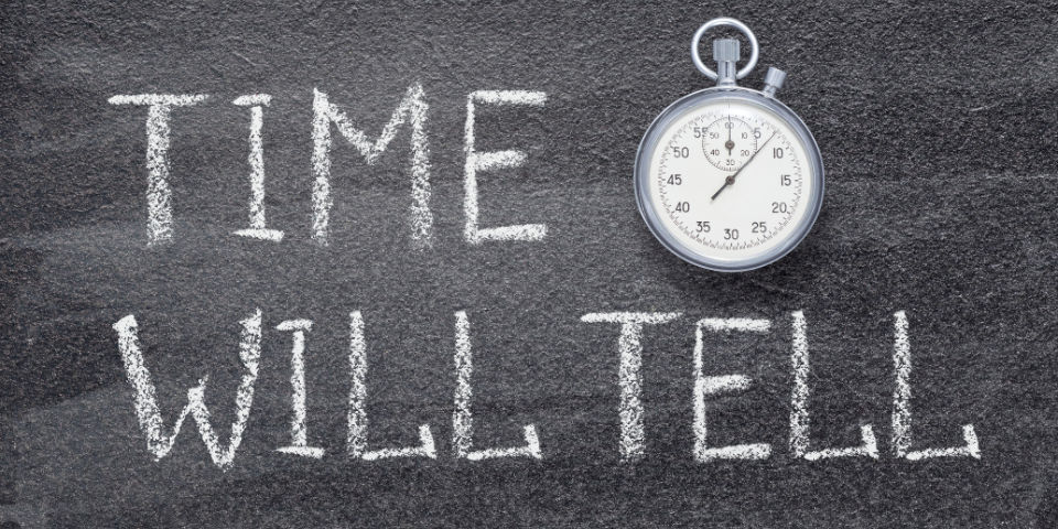 Collection of four insulated travel bottles on wooden shelf.