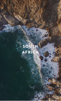 Tall slender porcelain bottle with natural clay textured body and cork stopper.