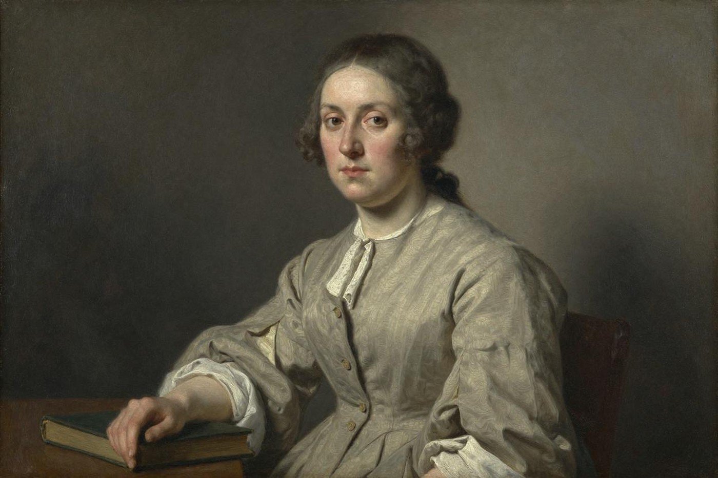 Oil portrait of a serious 18th-century woman in plain dress, one hand resting on a closed book