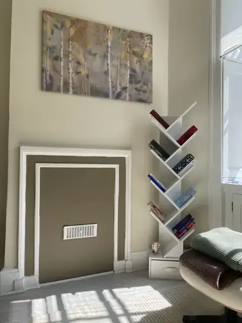 Central London therapy room with fireplace and artwork