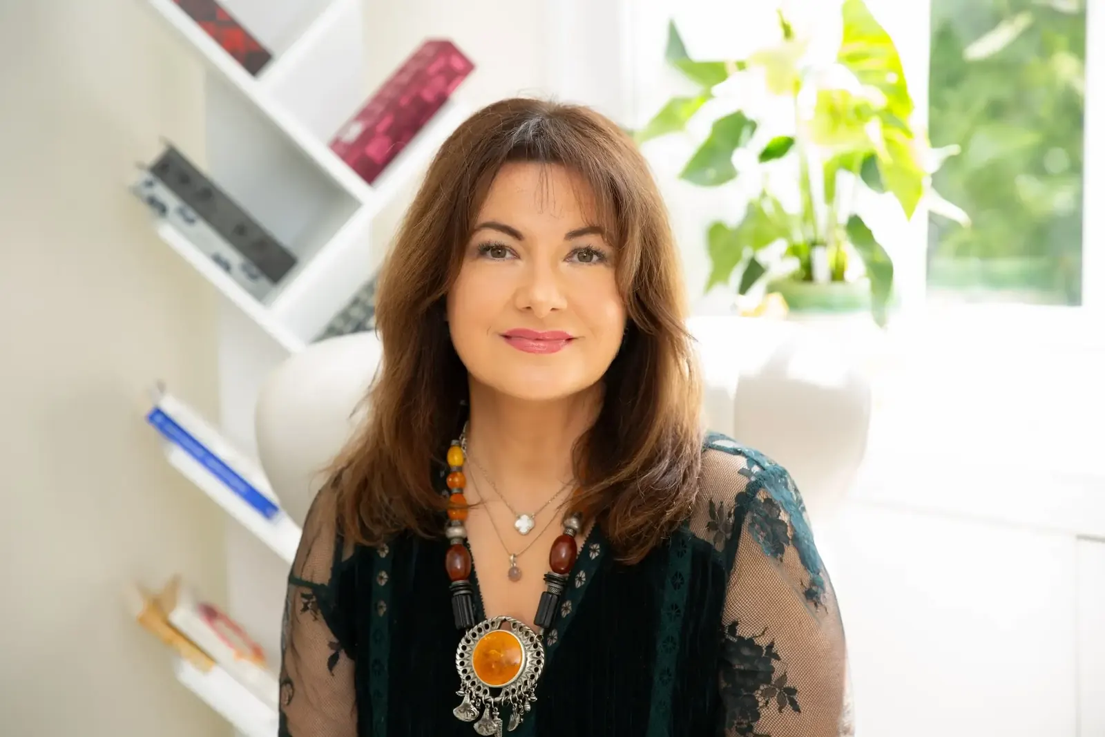 Artemis Manias, Chartered Psychologist in Richmond, smiling in her therapy room