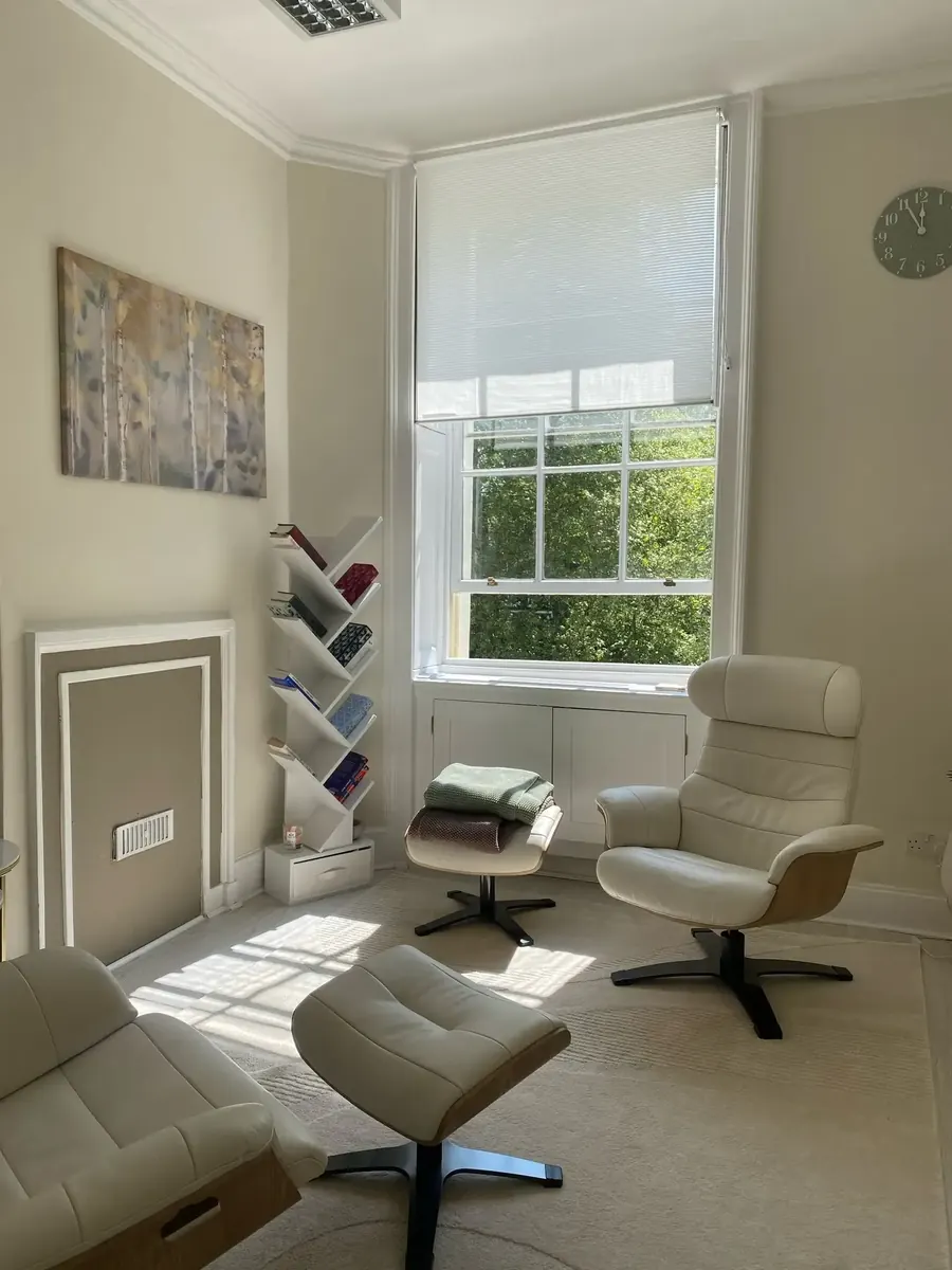 Bright therapy room at 20 Bedford Square, Central London, with two armchairs by the window