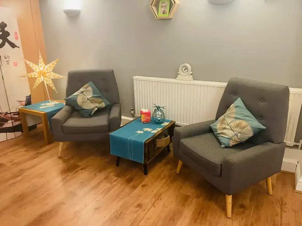Therapy room on Lower Mortlake Road in Richmond, with two grey armchairs