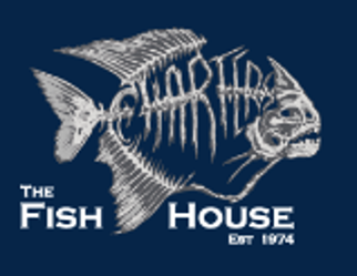 Desk with leather desk pad, walnut desk organizer, wireless keyboard and mouse, and porcelain mug.