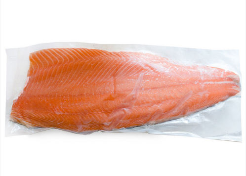 Wood table with porcelain mug, leather journal, brass pen, leather key ring, and a houseplant.