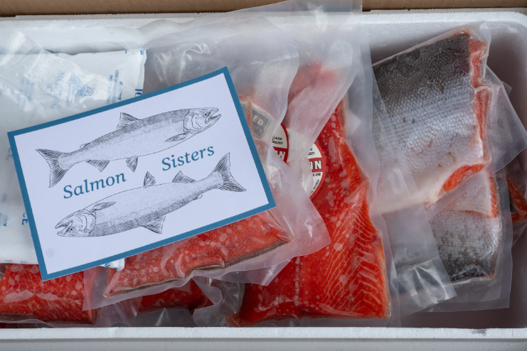Collection of four insulated travel bottles on wooden shelf.