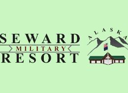 Wood table with porcelain mug, leather journal, brass pen, leather key ring, and a houseplant.