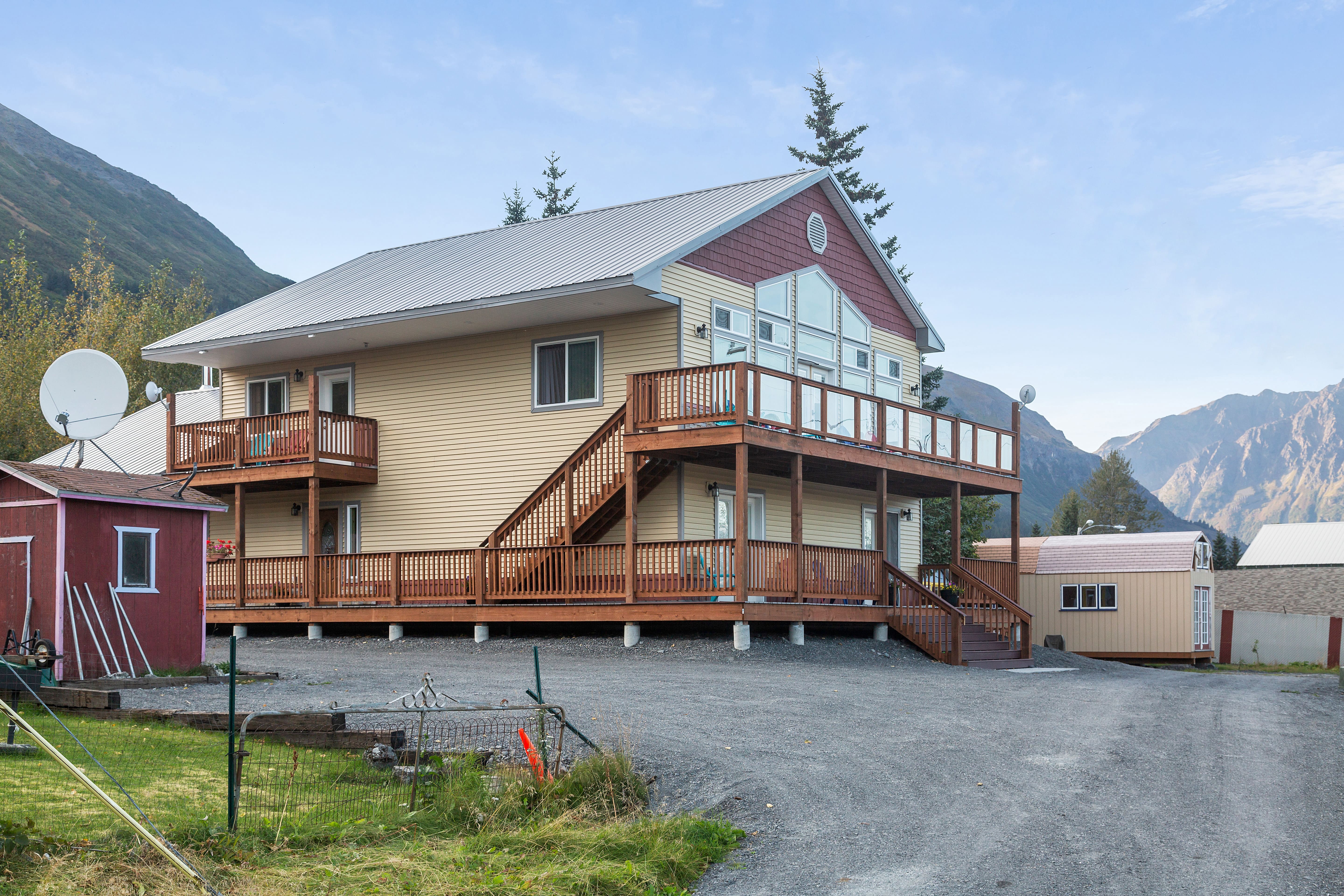 Desk with leather desk pad, walnut desk organizer, wireless keyboard and mouse, and porcelain mug.