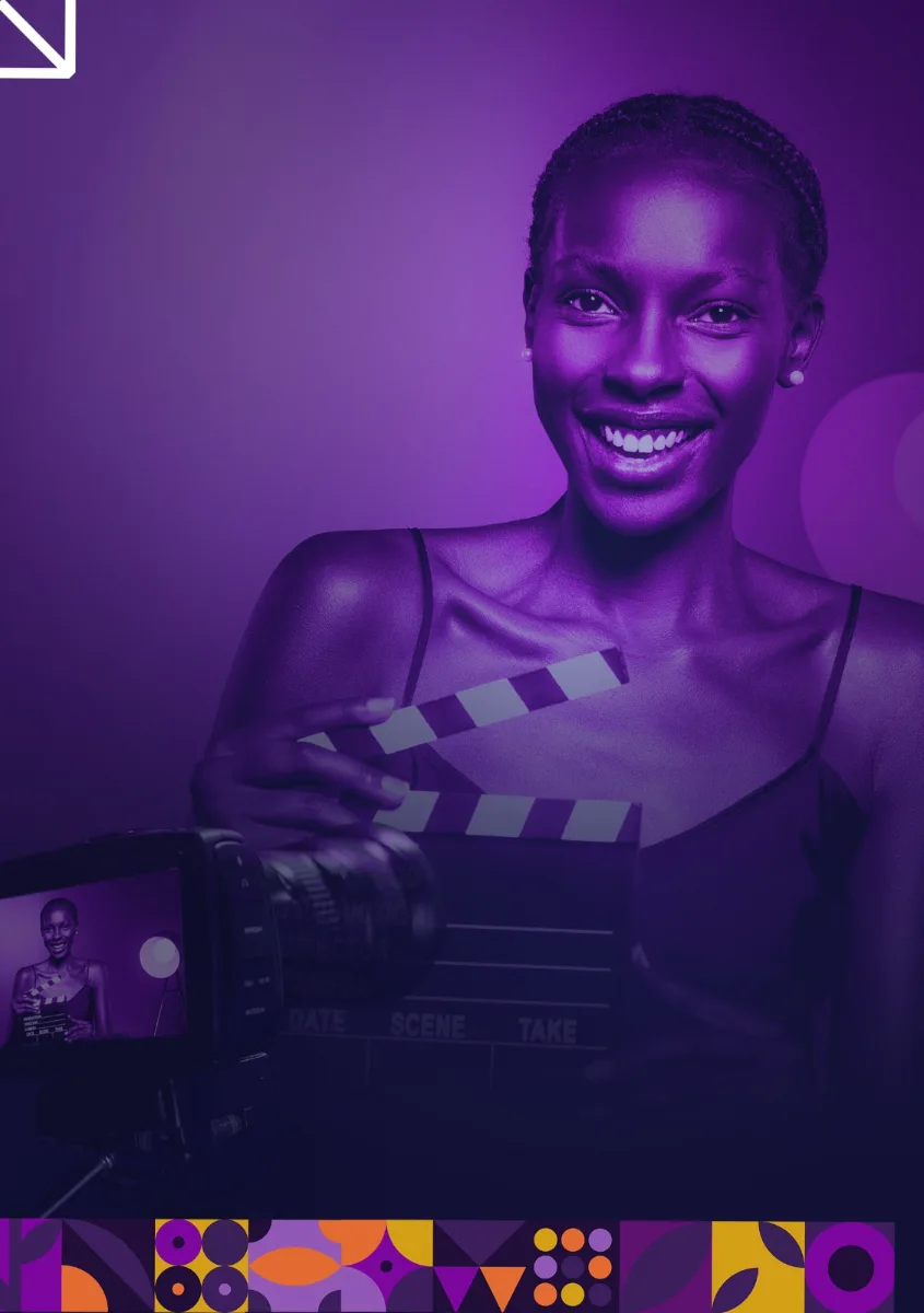 A Revele Creative Academy student holding a clapperboard