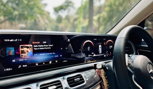 Dashboard of a Mercedes-Benz S-Class, featuring a sleek design with digital displays and luxury controls.