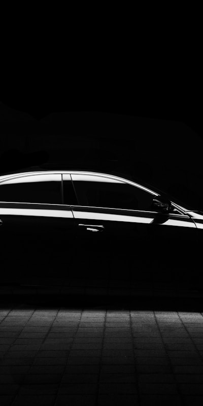 New Mercedes-Benz S-Class parked in a modern urban setting, showcasing its sleek design and luxury features.
