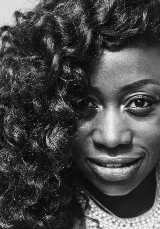 A black-and-white portrait of Sylvia smiling warmly