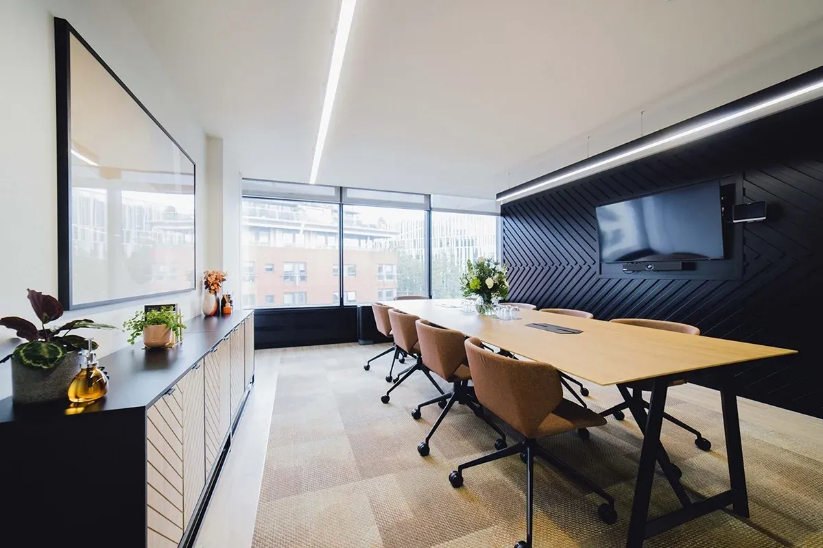 An advanced English classroom in central London with a long table, natural light and a view over the city
