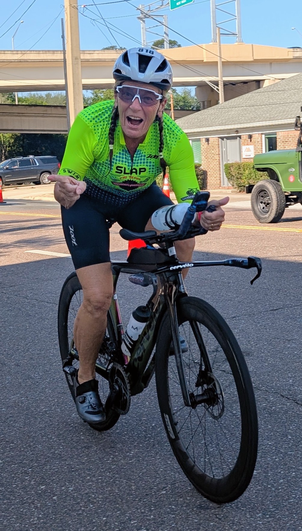 Julie riding her bike in SLAP team kit during a race
