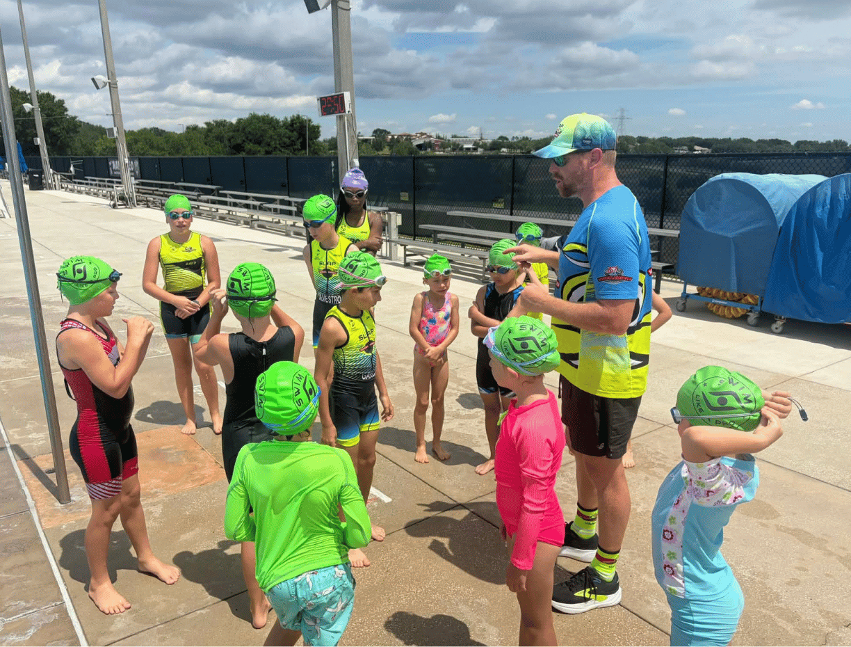 Youth team at a pool swim practice with Coach Kris