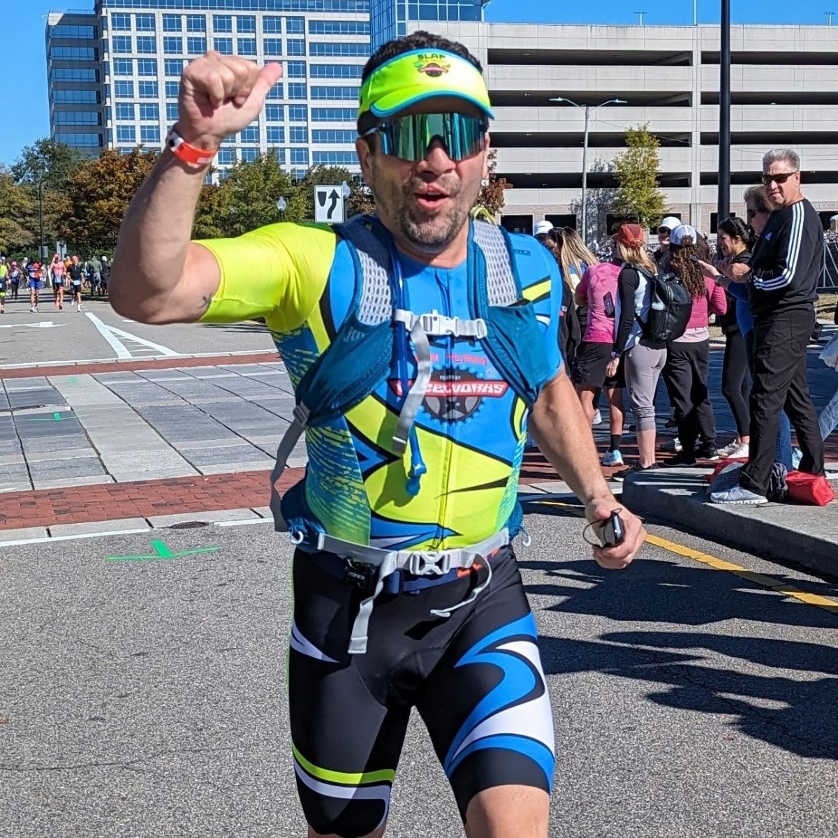 SLAP athlete running in team kit at Ironman