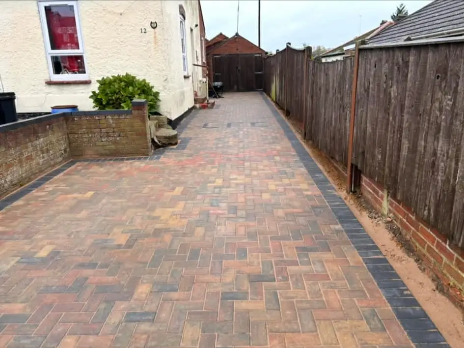 Driveway with low-maintenance gravel feature.
