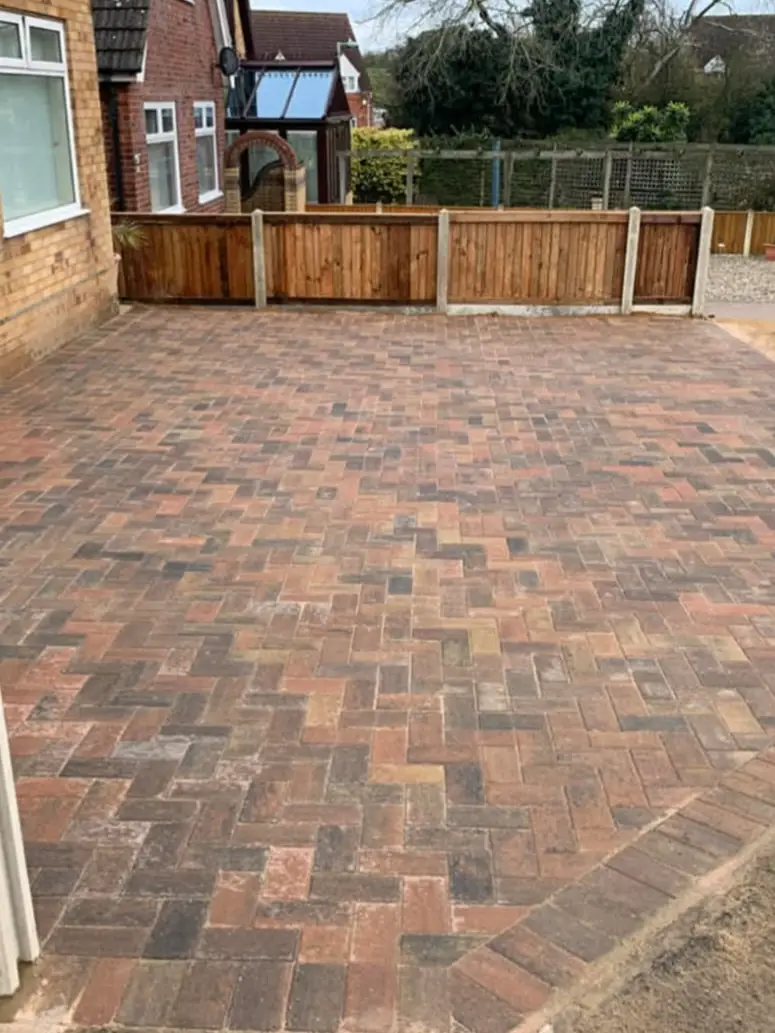 Driveway with matching steps up to front door.