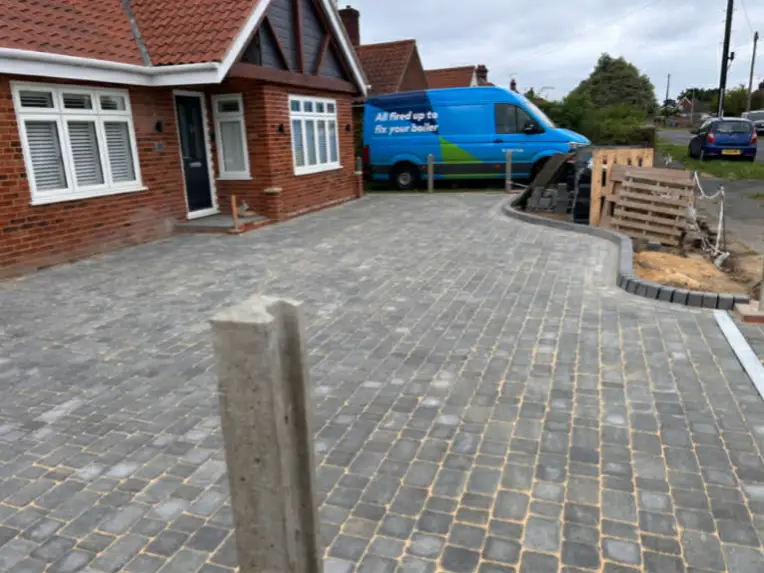 Driveway with integrated lighting along edge.