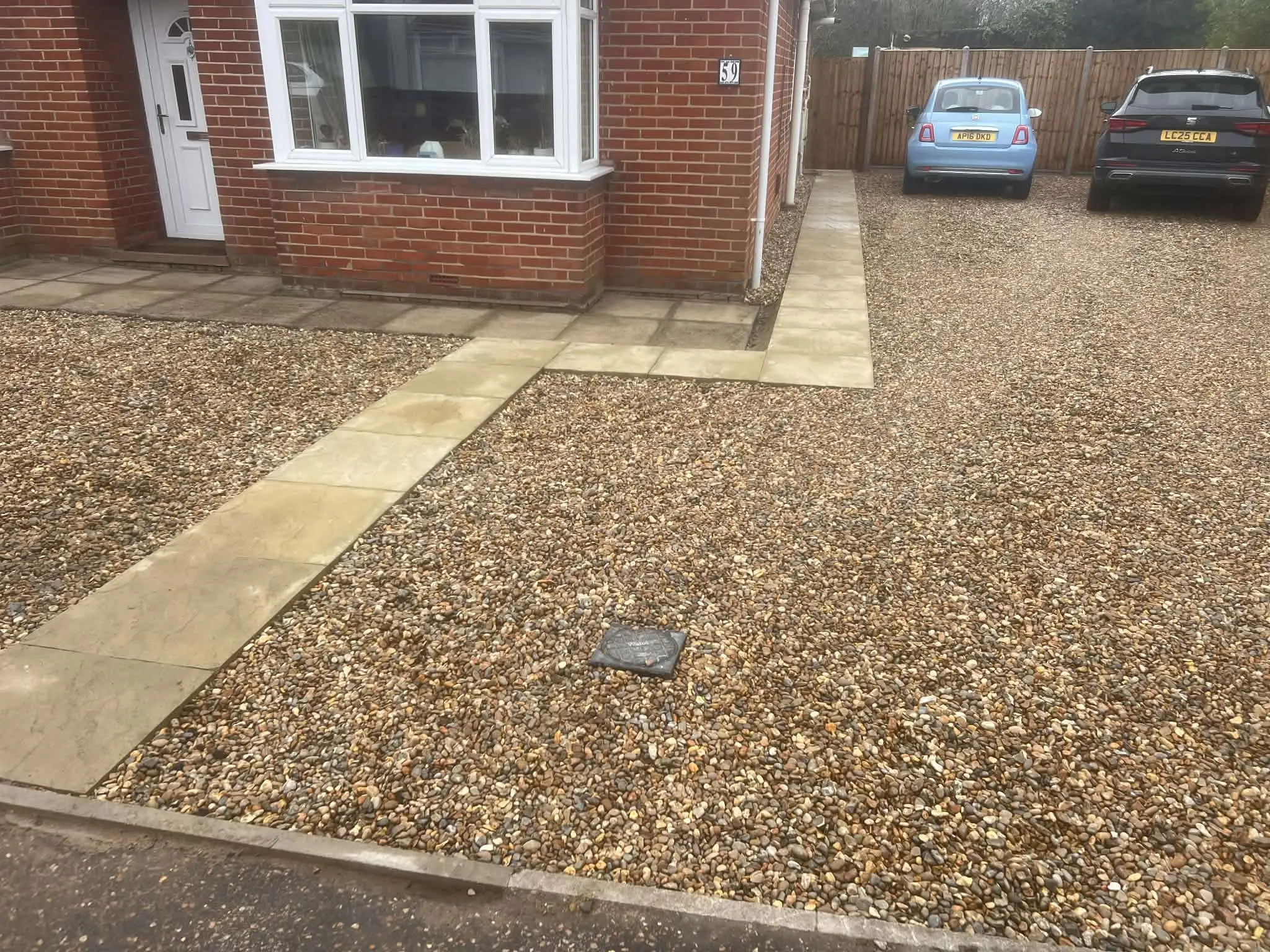 Driveway with contrasting kerb edge to lawn.