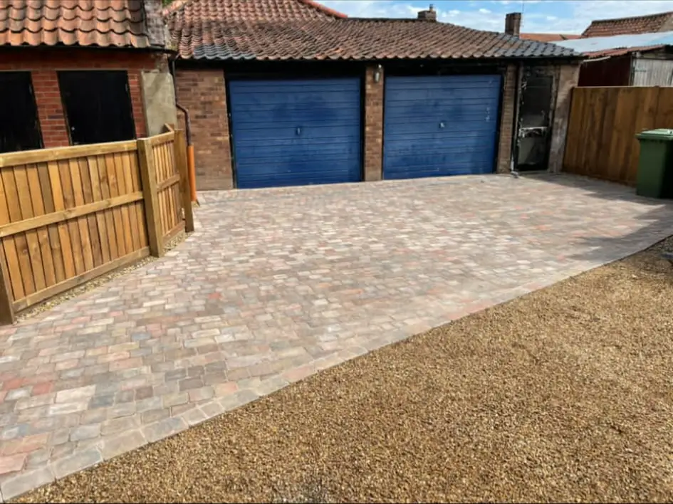 Driveway surface tied into front garden planting.