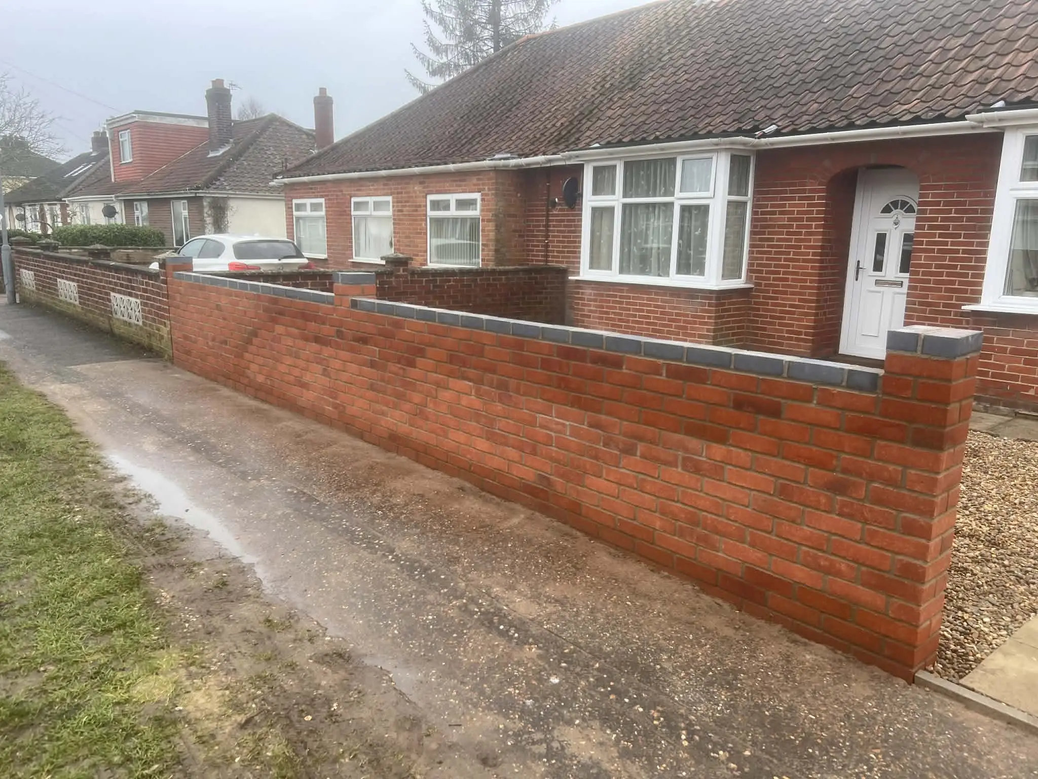 Garden path framed with clipped low hedging.