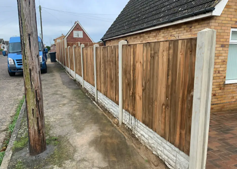 Close-up of timber garden fencing in sunlight.