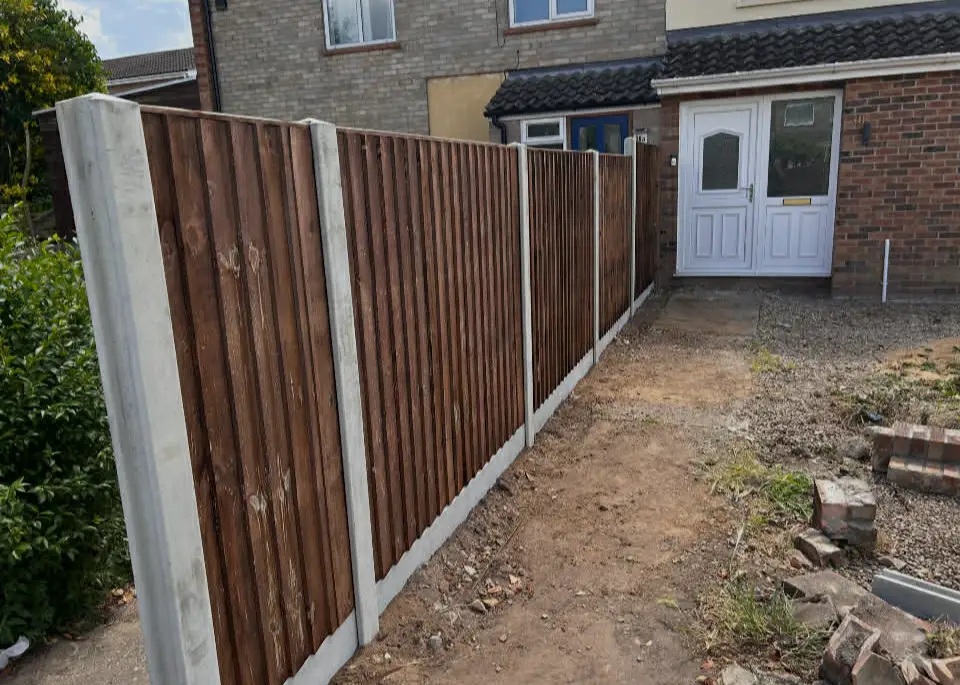 Horizontal slatted fence casting soft shadows.