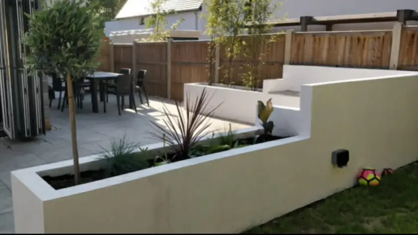 Layered garden with shrubs and small trees.