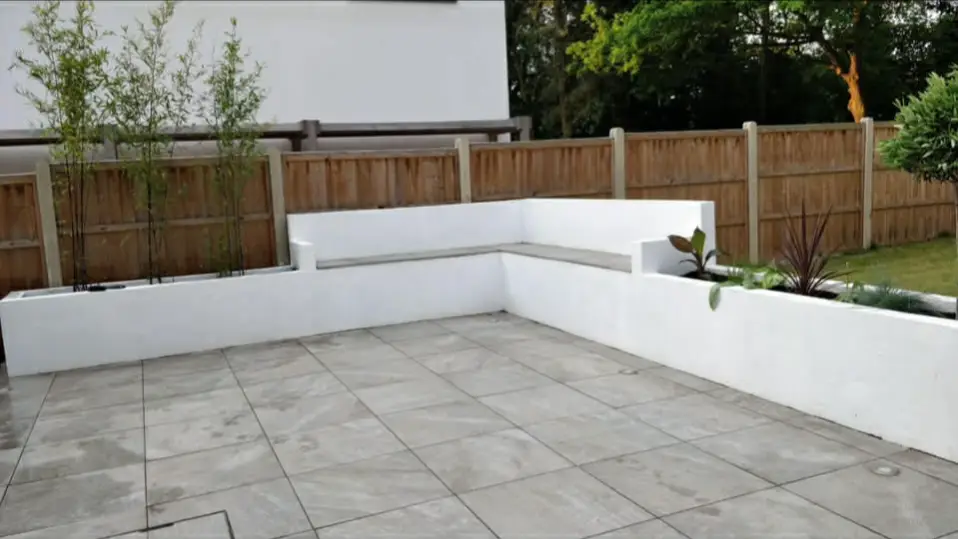 Planting bed layered from low groundcovers to taller shrubs.